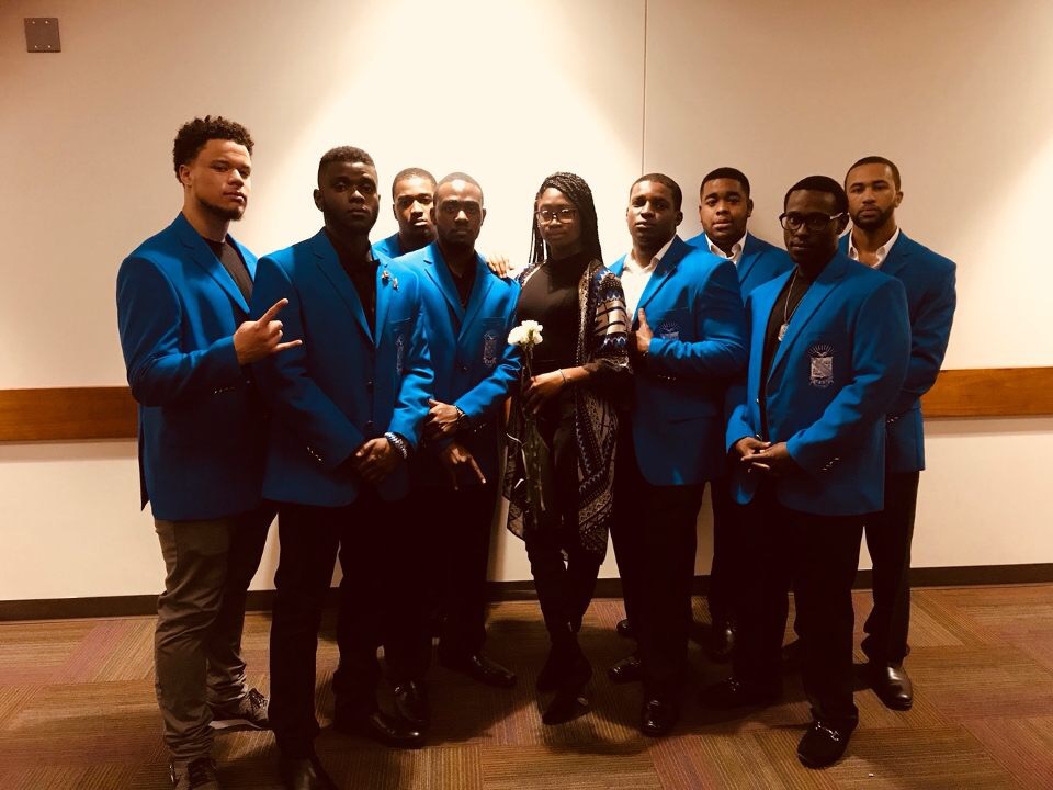 Brothers in blue blazers with award